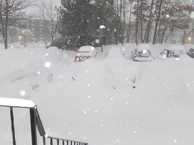 During the blizzard on Saturday, Jan. 23, all that’s visible of the cars in the foreground are their windshield wipers.
