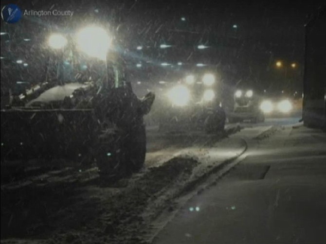 Snow plows work to clear Arlington streets.
