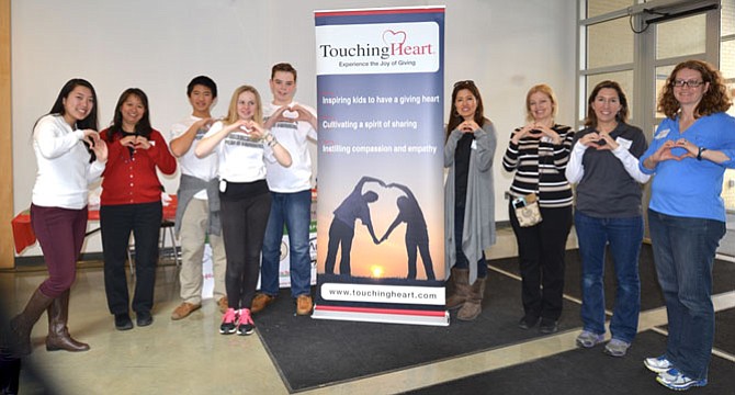 Organizers, staff and associates of Touching Heart show their signature move at the 2016 Minecraft for a Mission event to raise funds for local foster care programs and children.
