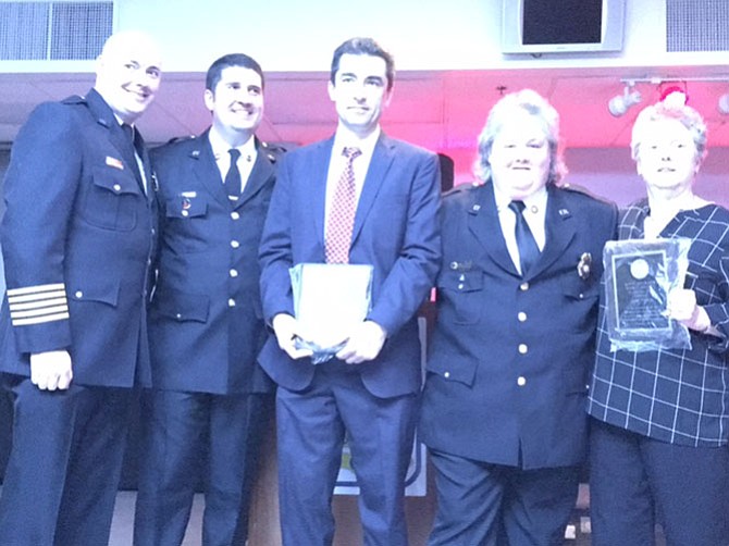 VVFD Chief John Morrison, VVFD president Anthony Stancampiano, and Auxiliary president Joanie Dempsey present the Kate Johnson Spirit Award to Valentin Neacsu, department member, and Jane Towle, Auxiliary member.
