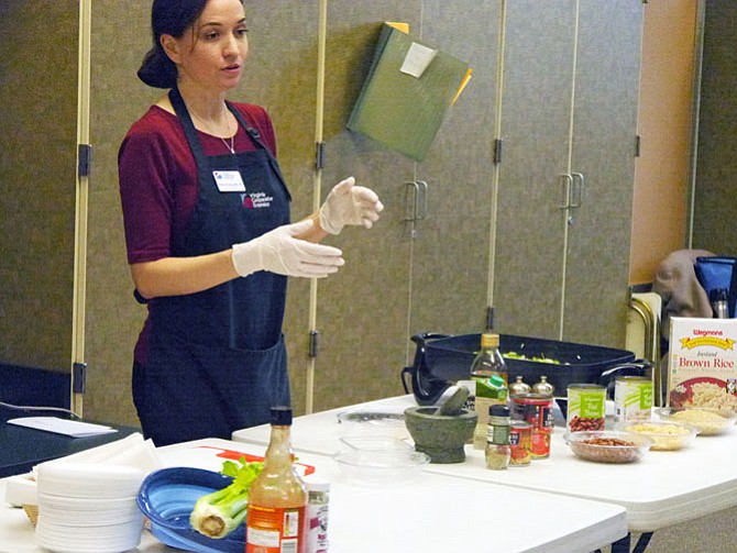 Katy Strong demonstrates a healthy vegetarian jambalaya by substituting vegetable oil for butter, cutting out the sausage and replacing the flavor with fennel plus garlic and spices. This Mardi Gras Cooking class was offered Feb. 8 at Langston Senior Center on Lee Highway.
