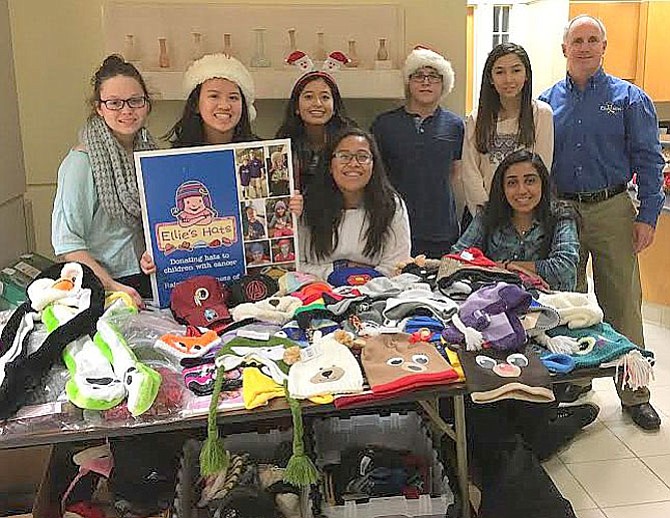 Wildcats vs. Cancer club members with some of the hats they collected for young cancer patients.