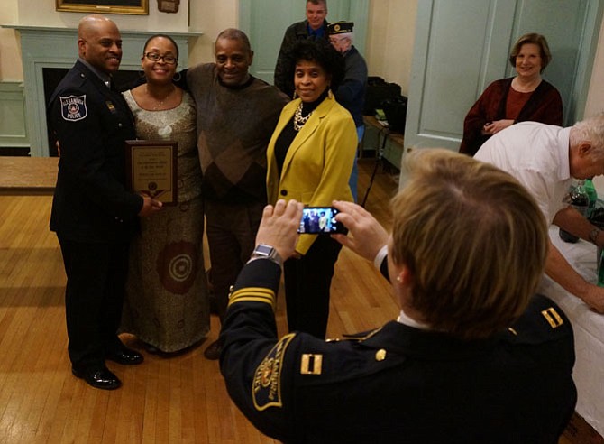 Officer Carl Stowe Jr., left, along with his wife Jamine and parents Carl Sr. and Roberta Stowe, smiles as Capt. Monica Lisle takes a photo following the presentation of the 2015 Law Enforcement Officer of the Year award Jan. 13 at American Legion Post 24.
