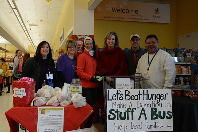 From left, Jennie Bush of Western Fairfax Christian Ministries, Giant Food employee Laura Fox, Julie Endersbee, U.S. Rep. Barbara Comstock (R-10), John Zarbo with Fairfax County Transit and Glenn Padeway, manager of Fairfax County Human Services Transportation, gather at a food donation site in the Clifton Giant Food on Feb. 6.