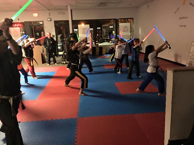 Students work on light saber skills during a class at Dietrich's Karate Fitness and Life Skills in Burke.
