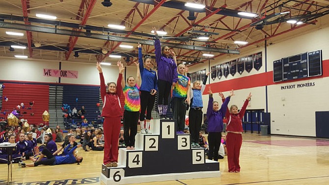 McLean gymnasts Carolyn Brown-Kaiser, far left, and Anna Brower, far right, finished sixth and seventh, respectively, on vault at the 6A North region meet on Feb. 13 at Patriot High School.