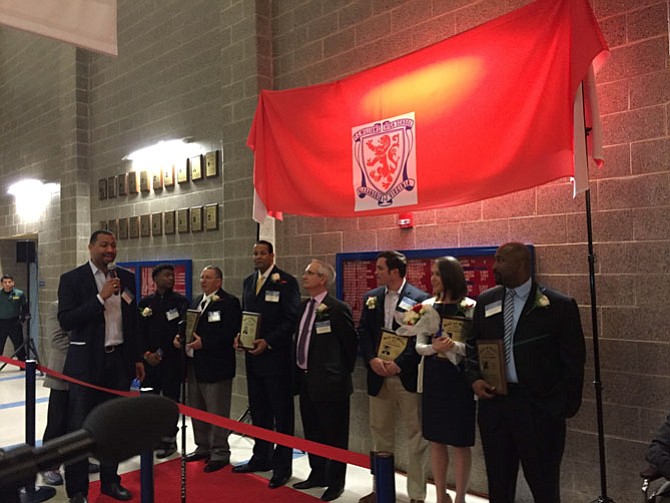 School Board Vice Chair Chris Lewis (left) prepares to unveil plaques for the Hall of Fame inductees.
