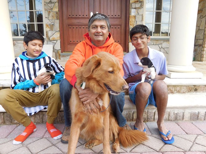 From left, Sachin Muralidhar, his father and brother Sid with foster Border Collies and Sparky (front).
