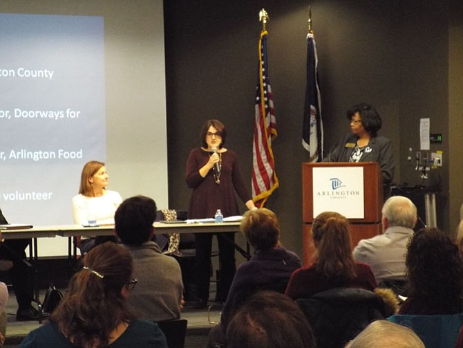 Wanda Pierce, executive director of Arlington Community Foundation, at podium moderating panelists Anita Friedman, director of Arlington County Department of Human Services (standing with microphone), and Caroline Jones, executive director of Doorways for Women and Families.
