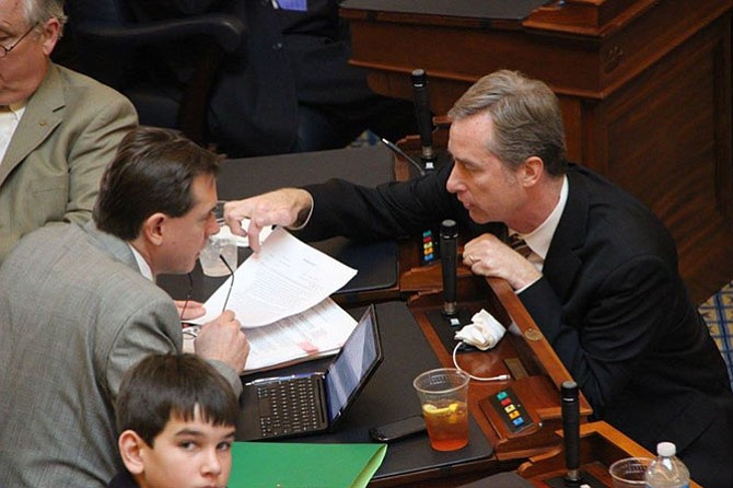 Del. David Bulova (D-37) works with Del. Jay Leftwich (R-78) on the floor of the Virginia General Assembly House of Delegates.