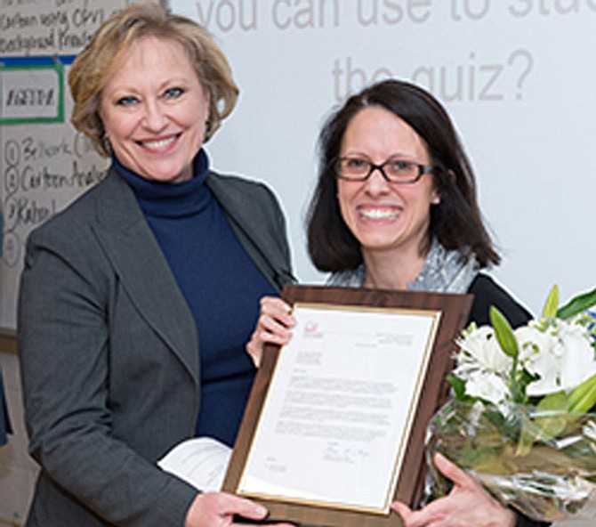 FCPS Superintendent Dr. Karen Garza awards Kilmer Middle School teacher Outstanding Teacher of the Year.
