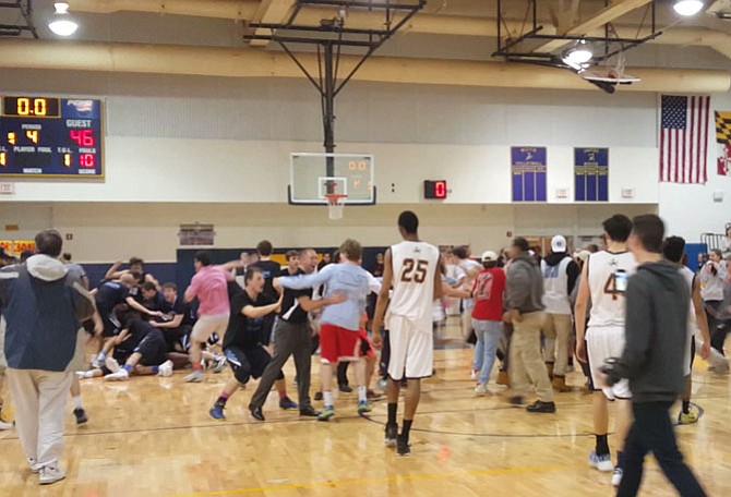 Whitman players and fans celebrate after the Vikings defeated B-CC on a buzzer-beating putback by Max Oppenheim in the 4A West section semifinals on Monday.