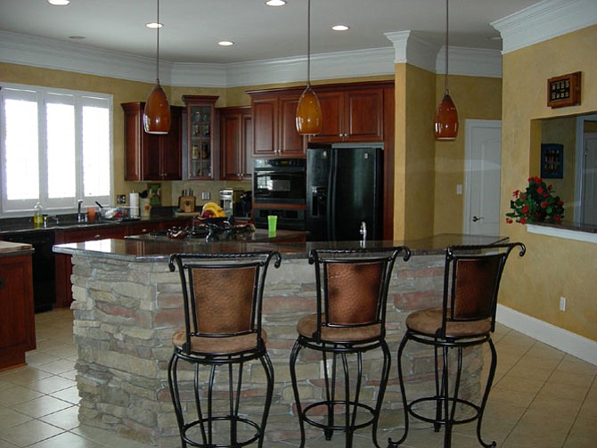 What’s wrong with this picture? It’s a gorgeous kitchen, but real estate agents will tell you that the green plastic cup, the dishwashing soap and the drainboard should all vanish from the selling photos of your house, and certainly during any showings.
