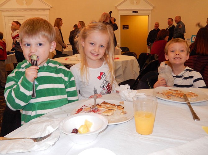 The Prentice siblings (from left) Luke, 2, Emma, 4, and Connor, 6, have fun at the breakfast.
