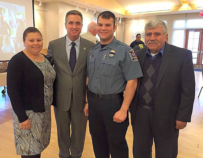 Police Officer Alex Jara with his parents and Fairfax City Mayor Scott Silverthorne (wearing tie) at the awards ceremony.
