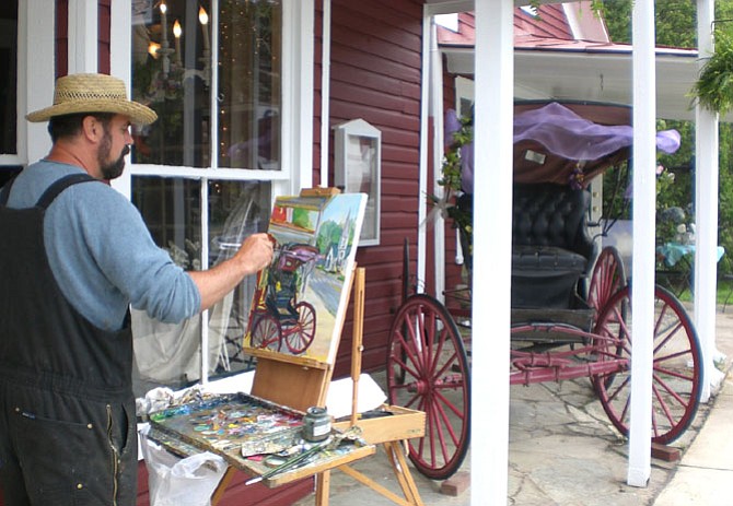 The picturesque nature of Clifton’s Main Street drew Warrenton plein air artist Palmer Smith to the town around 2008, when he set up his easel to paint town landmarks, including the antique buggy in front the Heart in Hand restaurant.  Smith belongs to the recently formed Art Guild of Clifton.
