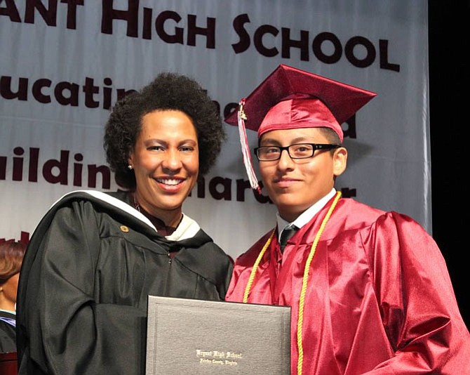 Bryant Principal Millard (left) congratulates Winter 2016 graduate Oscar Moya-Copa.