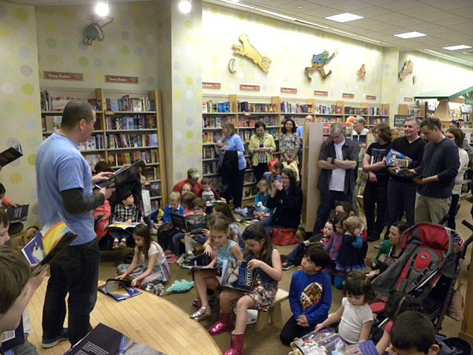 Scott McBride faces an audience of children, friends and family, as he reads from his book in front of a hometown audience at Barnes and Noble in Tysons Corner on Saturday, March 12.
