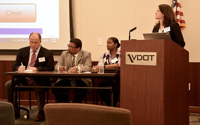 At the table were Todd Horsley from the Virginia Department of Rail and Public Transportation, Nick Nicholson of the I-66 Team, and Renee Hamilton, VDOT deputy district administrator. Amanda Baxter, VDOT special projects manager stands behind the lectern.