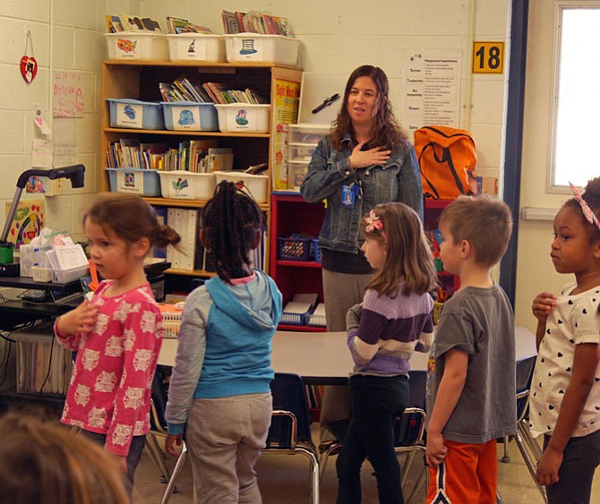 Kate Martin joins the morning school program “Good Morning the MacArthur Show” in leading the pledge of allegiance for her kindergarten class on Wednesday morning.
