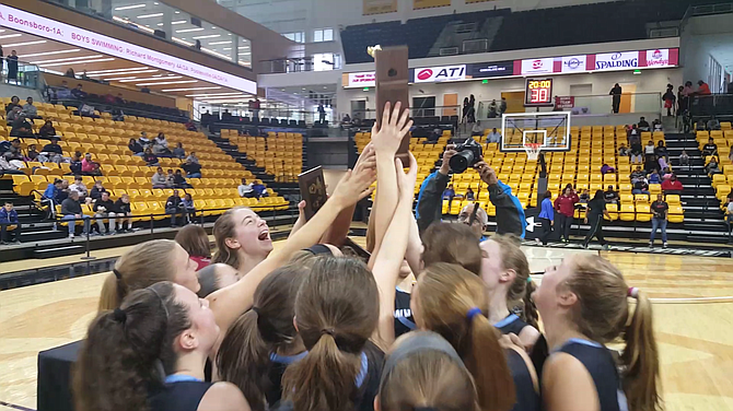 Members of the Whitman girls’ basketball team celebrate winning the state championship. The Vikings defeated Western 71-55 in the 4A final on March 12.