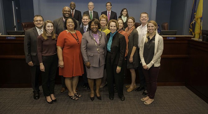 Front row, from left, are Olivia Burnett, Arlington Pediatric Center, Virginia Hospital Foundation; Elizabeth Jones Valderrama, executive director, OAR of Arlington County; Rosie Allen-Herring, president & CEO , United Way NCA; Libby Garvey, chair, Arlington County Board, Amanda Mark, A-SPAN. Second row, from left, are Angelo Rivero, director, CASA de Virginia; Sam Kelly, executive director, Bridges to Independence, Inc., Jay Harris, Arlington Partnership for Affordable Housing board member, Cheryl Ramp, director of Community Relations, APAH; Nina Janopaul, president and CEO, APAH; Scott Miller, A-SPA. Third row, from left, are  Arlington County Board Christian Dorsey, board member, John Vihstadt, board member; Jay Fisette, vice-chair, board member; Katie Cristol, board member.
