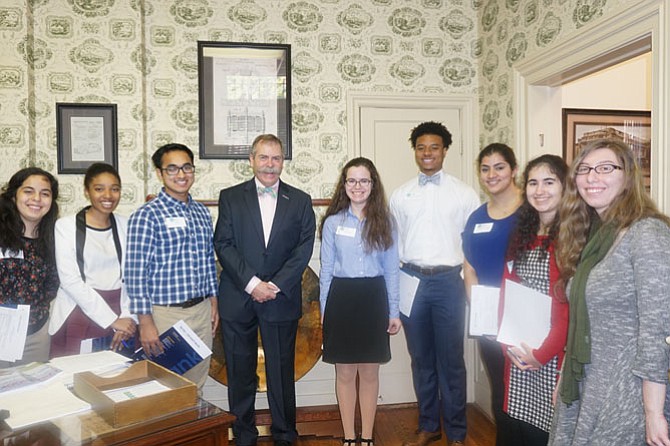 Bank Day students meet Burke & Herbert Bank Chairman & CEO E. Hunt Burke. From left are Micala Gimenez (Osbourn Park HS, Manassas); CaiLynn Birts (Mt. Vernon HS); Nisan Shretha (Hayfield HS); Mr. Burke; Olivia Ireland (West Potomac HS); Jordan Randle (St. Agnes/St. Stephens School, Alexandria); Yasmin Azam (Robinson Secondary); Melisa Dag (Lake Braddock Secondary); and Doriana Lichter (W.T. Woodson HS).
