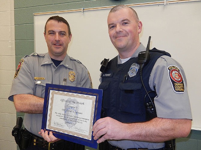 (From left) 1st Lt. Matt Owens presents Officer David Stewart with a certificate honoring him as February’s Officer of the Month.
