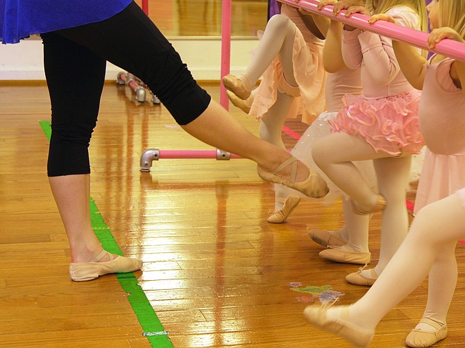 “Dégagé,” Jessica Petchenick demonstrates for her 2-3-year-old Wiggle Toes class at Tiny Dancers on S. Washington Street. 