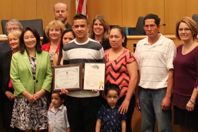 Herndon Middle School student Roberto Morales Castillo, second from left, saved his family and numerous other families from carbon monoxide poisoning the day of the blizzard in January. 
