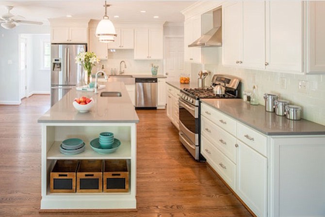 The kitchen of this newly remodeled Bethesda home includes a walk-in pantry, breakfast area, Caesarstone countertops and a Kohler vault apron front sink.