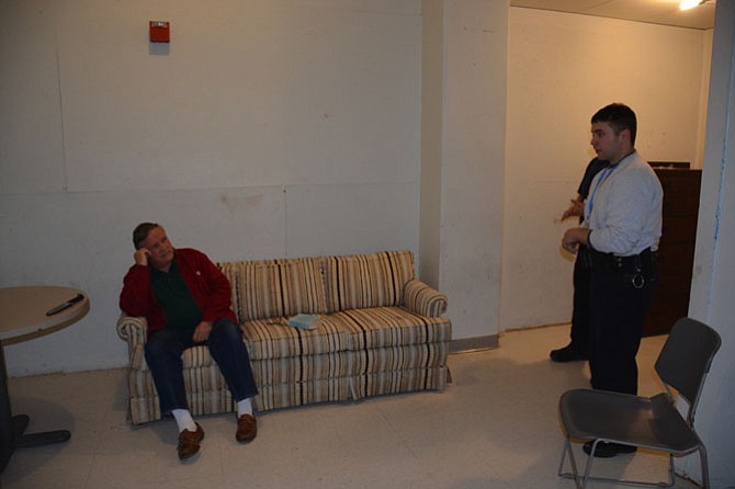Officers (right) enter a fake residence to talk with a man role-playing as an emotionally disturbed person who was reported in the scenario to be suicidal.