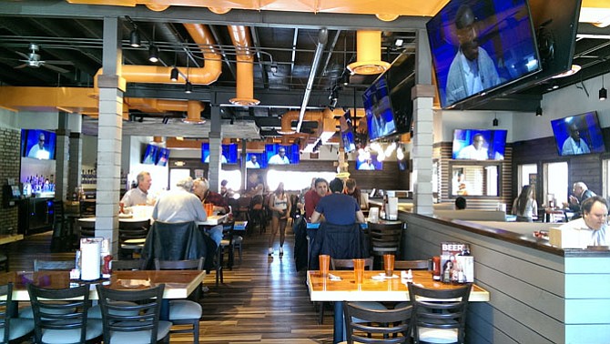 A bright, colorful interior greets Hooters restaurant patrons at the recently opened Fairfax location during lunch service.
