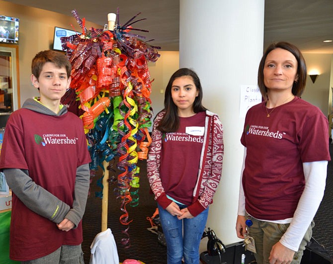 Even the Arts get in on the eco-friendly act. From left -- Lanier seventh-graders Aaron Harich and Jovanna Pineda were proud to display their chandelier, made over four weeks with about 150 recycled plastic water bottles, with the encouragement of Art teacher Kirby Kennedy.
