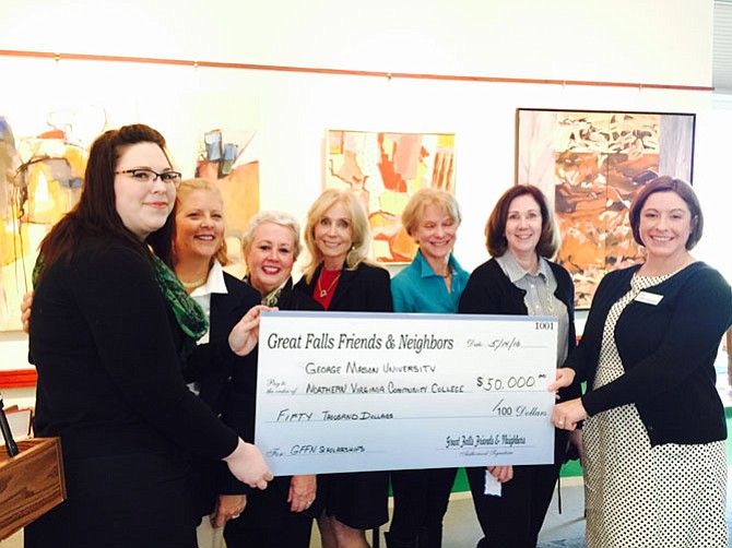 Laura Bumpus (second from left), Ricky Harvey, Annette Kerlin, Kristen Trimble and Anne McVey of the Great Falls Friends and Neighbors present Mary Bramley, left, and Libby Dissauer, right, with a $50,000 endowment to be used for annual scholarships for adult women pursuing education at Northern Virginia Community College and George Mason University.
