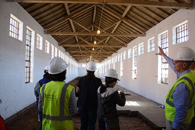 (Right) Scott Carver of Oakton, Director of DC Region and Northern Virginia for the Liberty Crest at Laurel Hill general contractor Southway Builders, Inc., explains how a “finger” building of former jail cells is being converted into apartments.