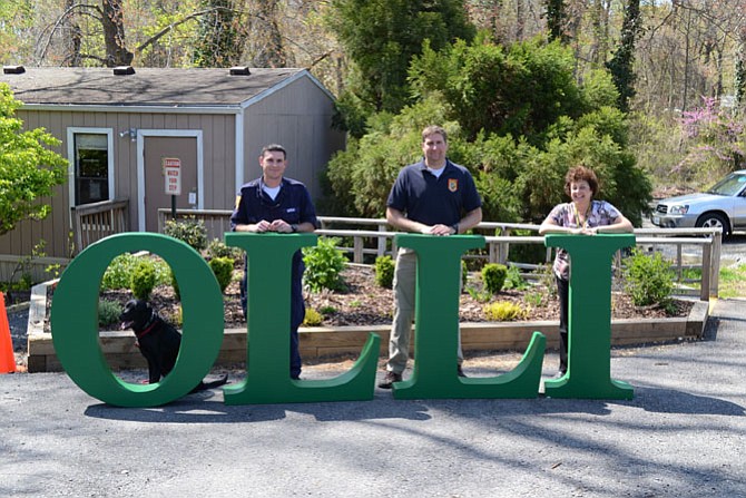 Angus, the dog; Search and Rescue Technician Paul Serzan, Search and Rescue's Lt. Scott Schermerhorn and OLLI Member Stephanie Trachtenberg.
