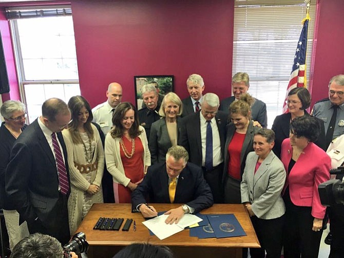 Gov. McAuliffe signs Del. Filler-Corn's House Bill 1102.

