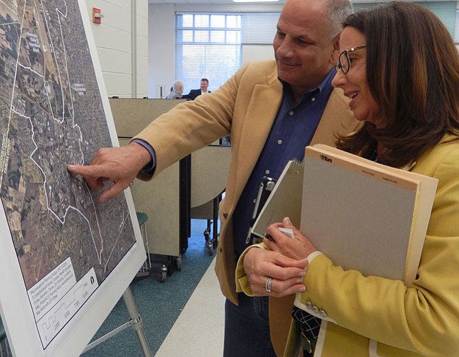 Virginia Run’s Ted Troscianecki and Laura Floyd, Sully District Supervisor Kathy Smith’s land-use aide, look at an aerial map of the site.
