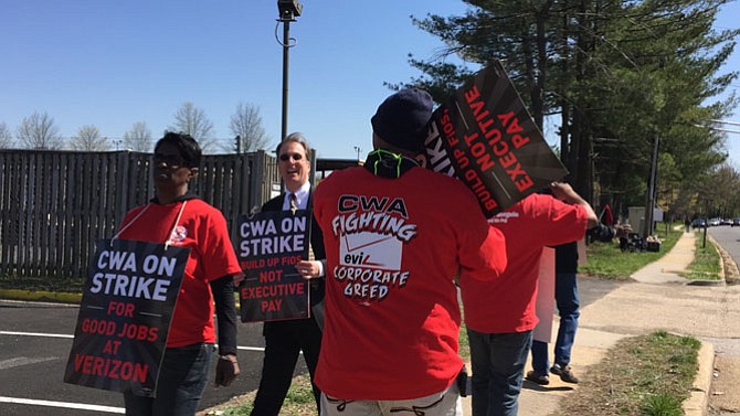 Del. Paul Krizek on the picket line with striking Verizon workers.
