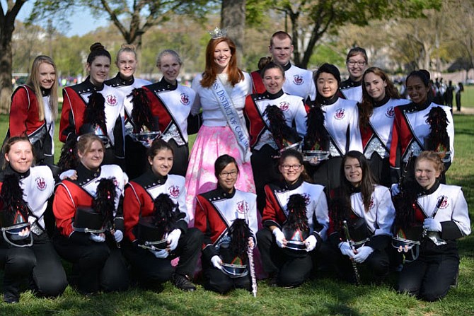 Miss District of Columbia poses with members of The Pride of Herndon during the Cherry Blossom Parade in Washington, D.C. on April 16.

