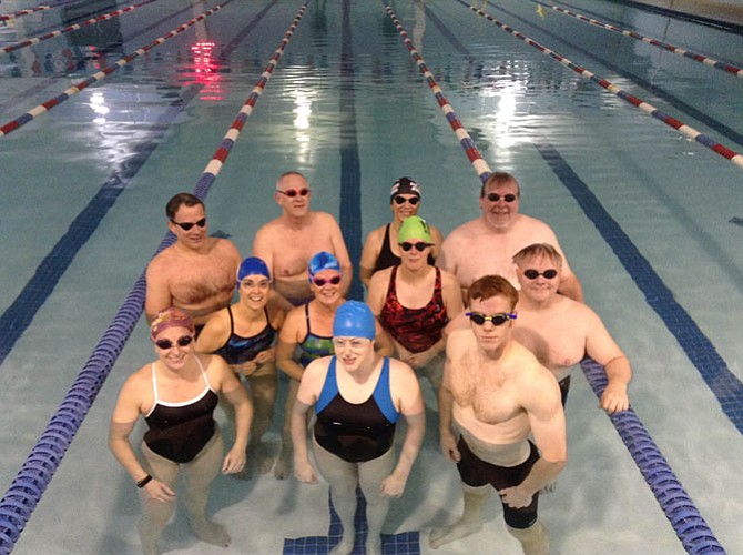(Center) Blind swimmer Michelle Duquette of Herndon is joined by members of the L4 Swimming masters program at Burke Racquet & Swim Club for the second annual “Swim Like Michelle” fundraiser.