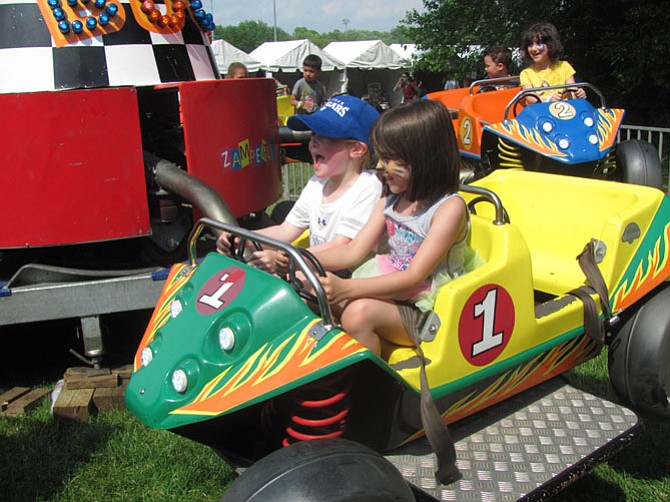 Caroline Ruddy, 5, at last year’s McLean Day, and friend Ariana Palmieri, 6, last year, enjoy a trip in a flying car, Chitty Chitty Bang Bang style, at McLean Day 2015.
