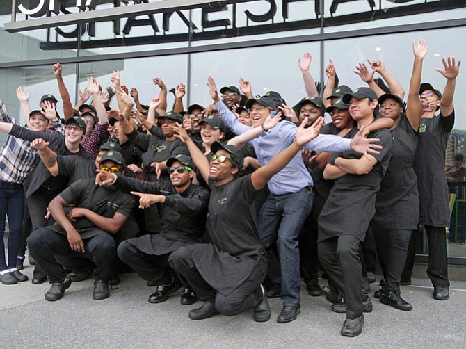 Employees for Shake Shack at Fashion City located at Pentagon City cheer the opening of the shop on Wednesday, May 4. This is the second Virginia location and the seventh in the metropolitan area. Shake Shack describes itself as a modern day “roadside” burger stand known for its 100 percent all-natural, antibiotic-free Angus beef burgers. 
