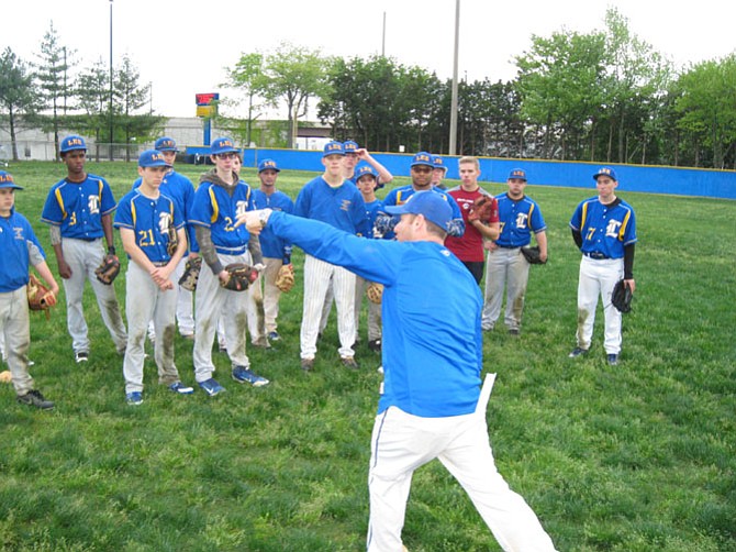 Lee High School baseball coach Matt MacDonald gives pointers to his team during practice.
