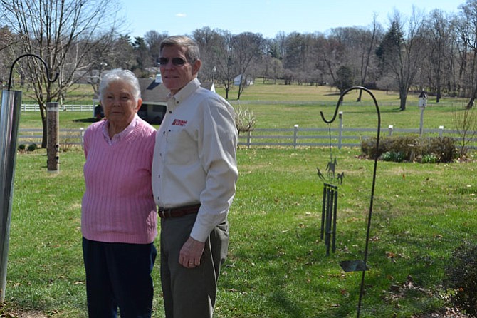 Jack Trunnell, CFO and co-owner of Trunnell Electric, stands with his mother Jean Trunnell in the yard of the family’s Potomac home. The company is celebrating 80 years in business.