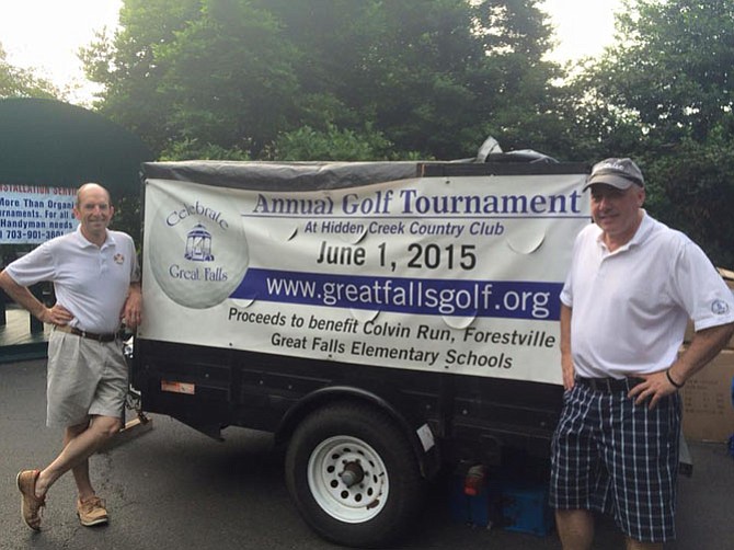 Tournament Chair Tim Burke (right) and  Mike Kearney holding up the sign last year.   