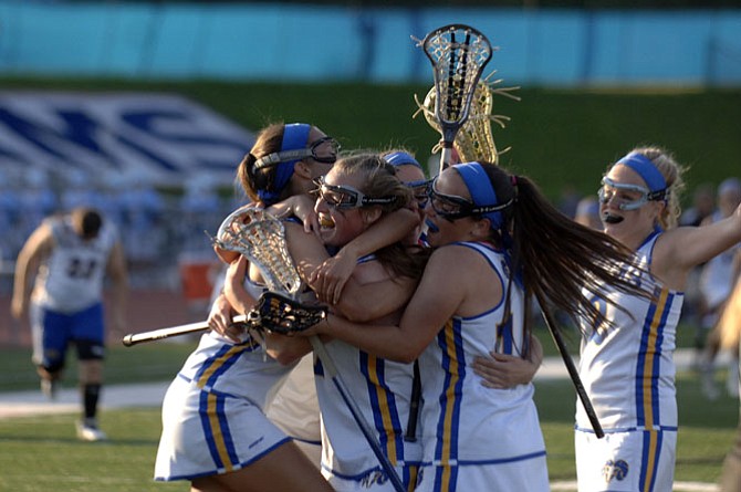 Members of the Robinson girls’ lacrosse team celebrate their 13-11 victory over Langley in the 6A North region quarterfinals on May 19.