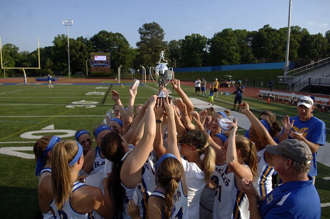 The Robinson girls’ lacrosse team celebrates winning its second consecutive 6A North region championship on Tuesday.