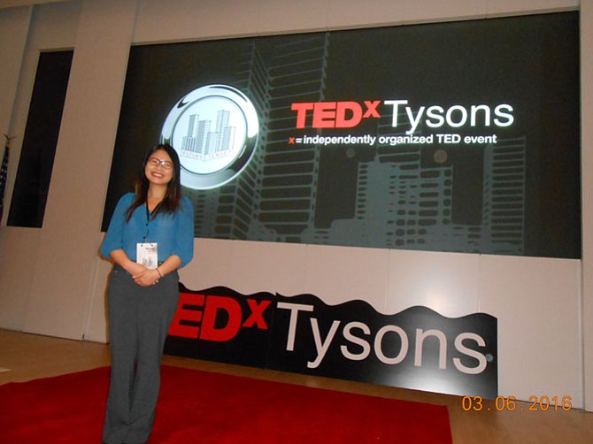 Student Vivian Dang stands on stage during a break in the inaugural TEDxTysons event.
